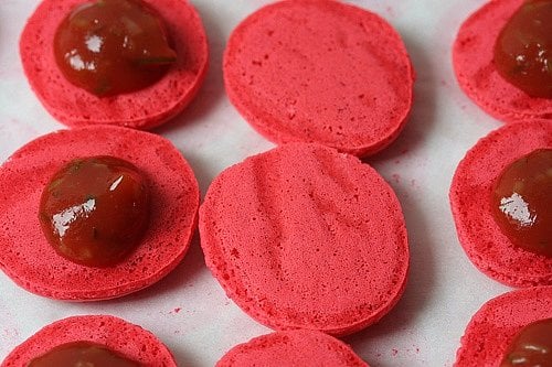 macarons filled with ketchup and cornichons