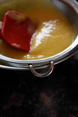 straining lemon curd