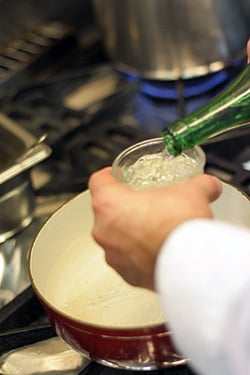 adding wine to fondue