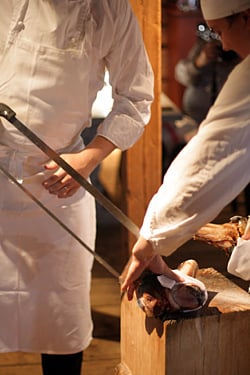 Fäviken cooks slicing meat