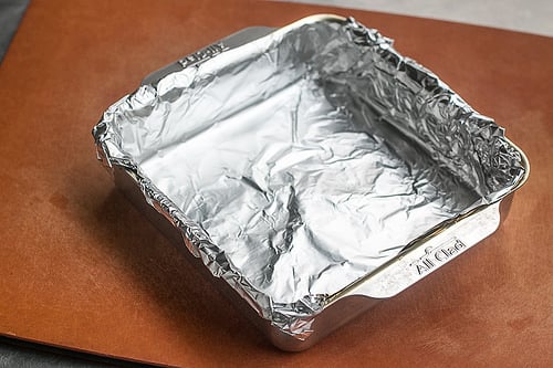 Wrapping foil tightly around the top of the pan for the first 15