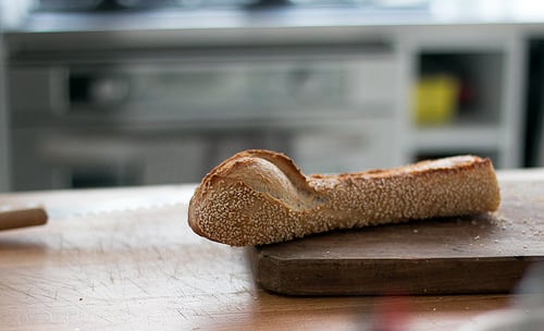 Baguette, European style bread on black wood table in morning time