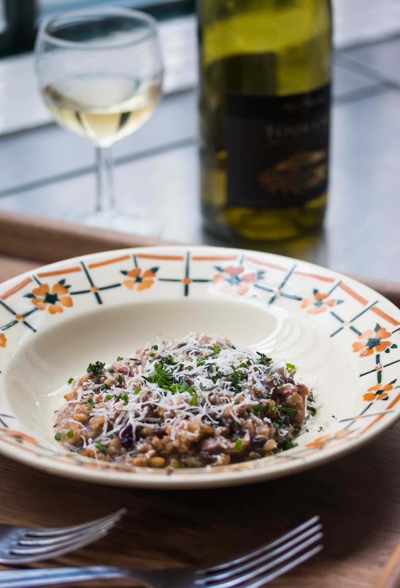 A delicious take on risotto with farro (cracked wheat), flavorful radicchio, and bacon. A great first or main course, or a hearty side dish too!
