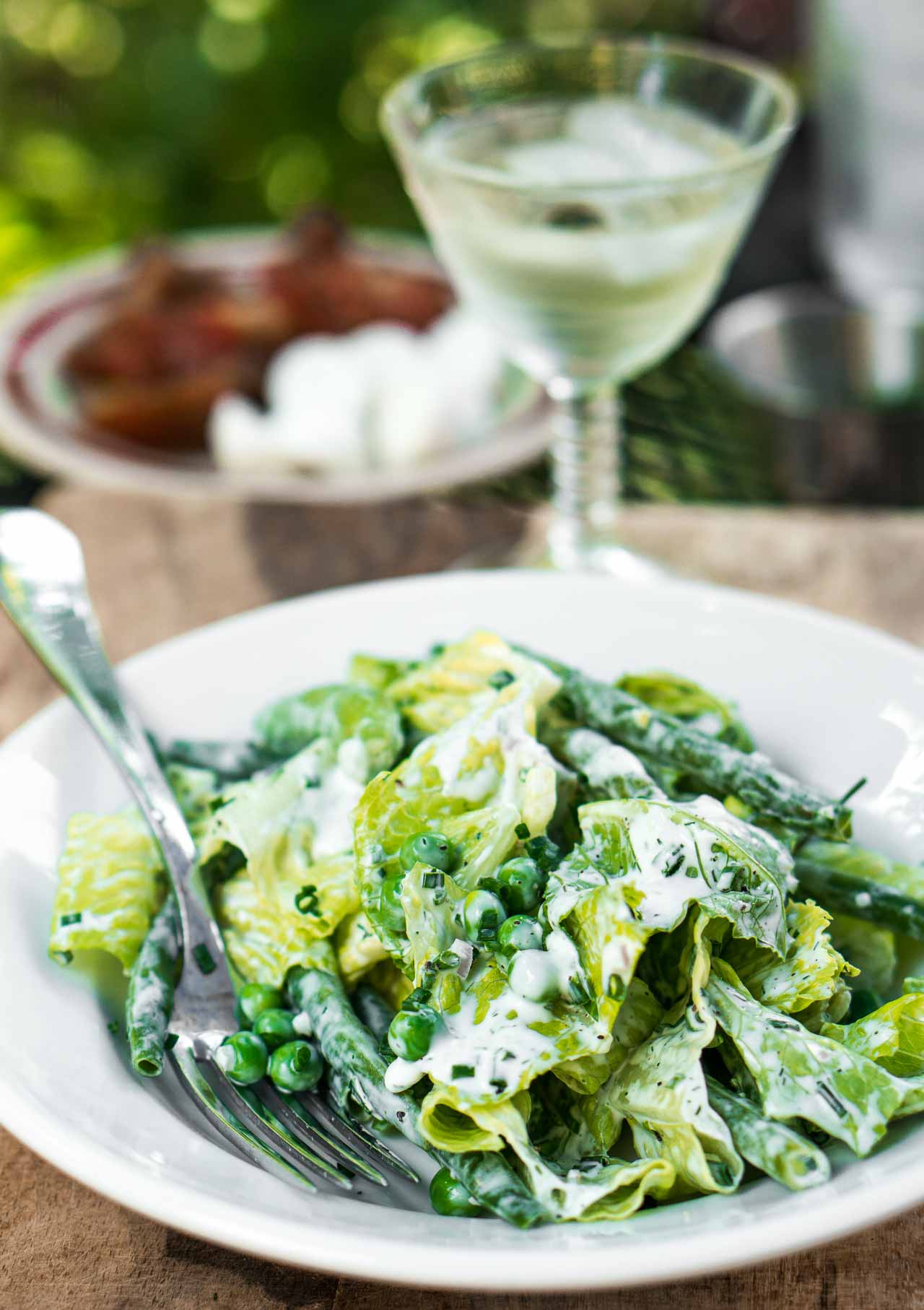 A lively green salad that celebrates the best of the season, in one bowl!